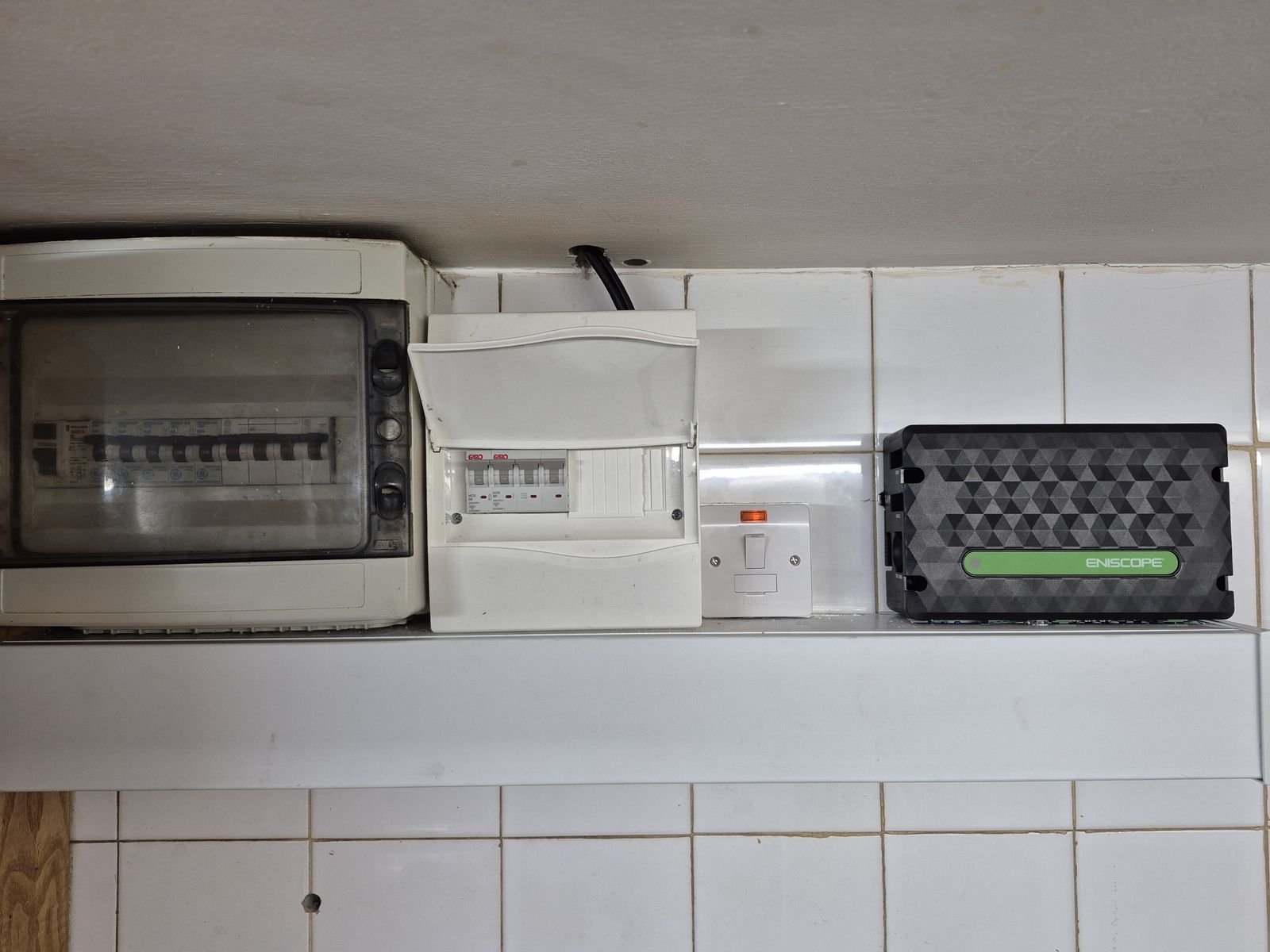 Eniscope energy monitoring unit installed beside a distribution board