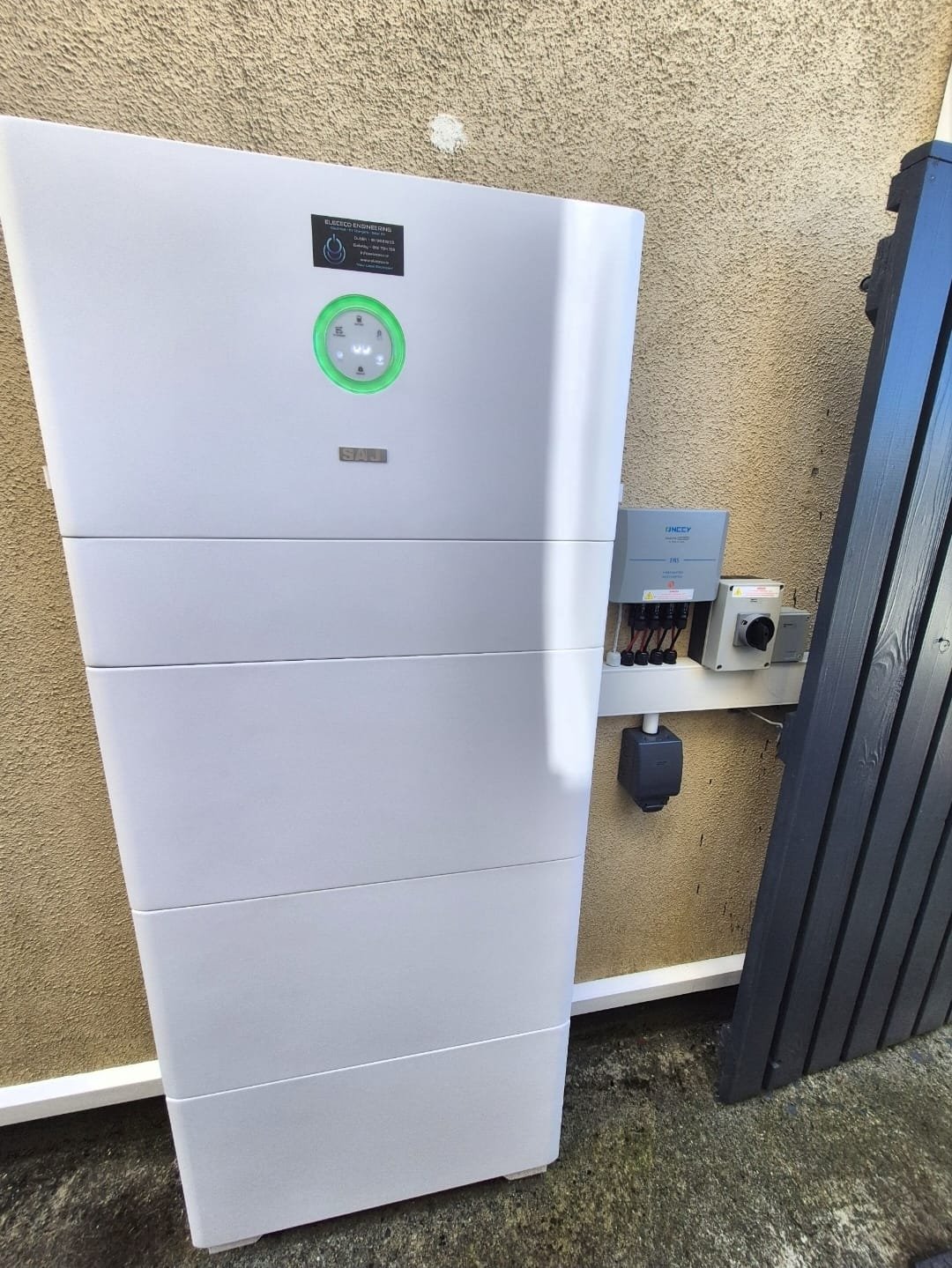 Sigenergy battery stack mounted against a house wall, by Elececo Engineering