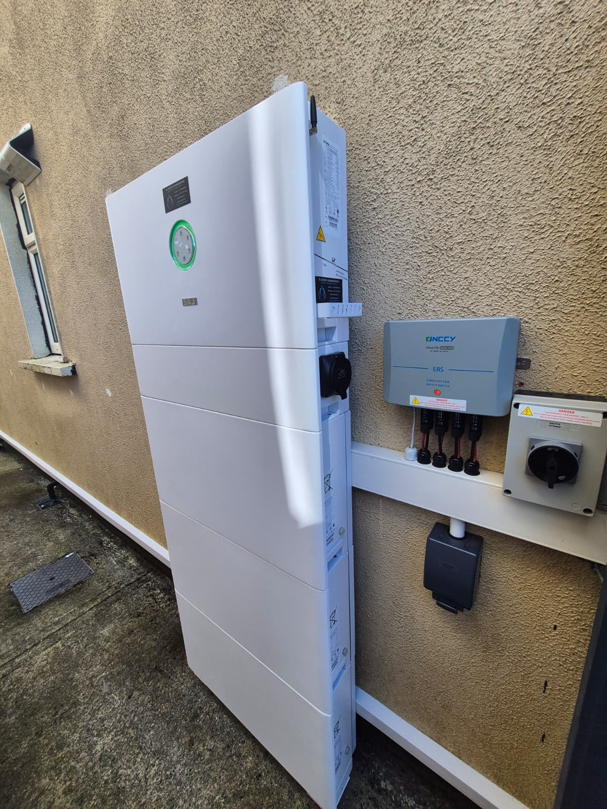 Sigenergy battery stack with isolators on an exterior wall, by Elececo Engineering