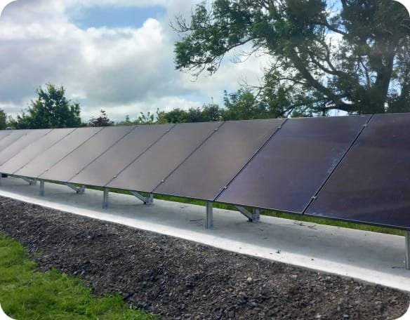 Row of ground-mounted Solar PV panels on a rural site, by Elececo Engineering