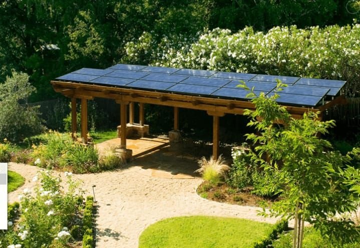 Solar PV panels on a timber pergola in a landscaped garden, by Elececo Engineering