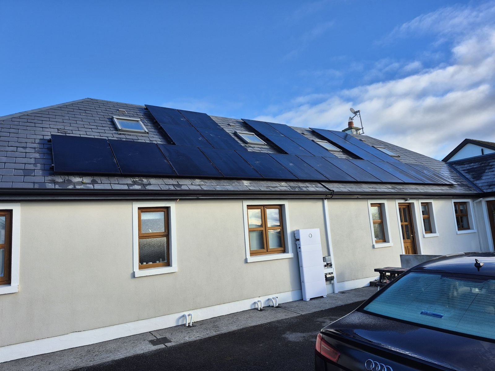 Black Solar PV panels on the roof of a dormer bungalow, installed by Elececo Engineering